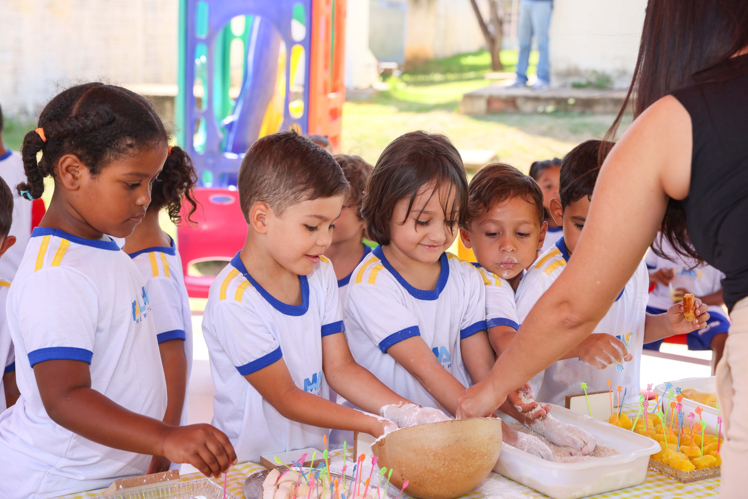 Alunos tocam o polvilho, derivado da mandioca, em atividade da Semana do Brincar, realizada nesta quinta-feira, 28